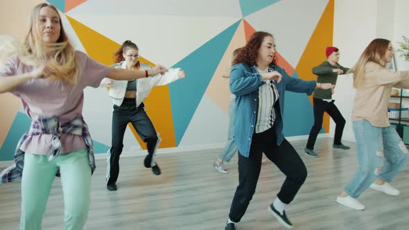 Joyful Students Dancing in Modern Hip-hop Studio Having Fun Together Indoors alt