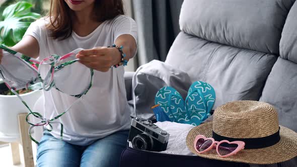 Young asian woman traveler preparing for the summer vacation, Travel concept	