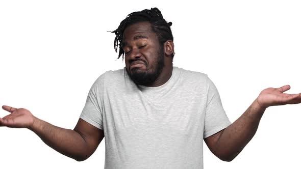 Portrait of Helpless African American Man with Afro Pigtails Throwing Hands Aside and Shrugging Don alt
