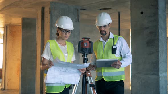 Architects Stand in Unfinished Building Close Up alt