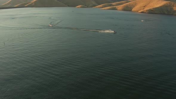 Aerial Drone Tracking Shot of Several Jet Skis on.a Mountain Lake (Lake Kaweah, Visalia, California)