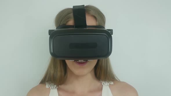 Sexy Woman In A Virtual Reality Helmet Uses The Application