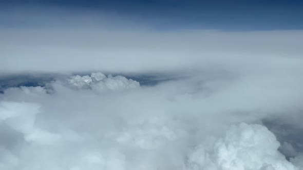 Airplane view of cumulonimbus stormy clouds from above alt