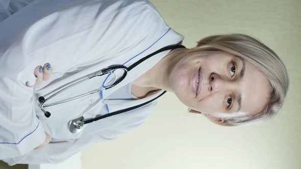 Cute Woman Doctor Blonde Looks Into the Frame and Smiles Beautifully alt