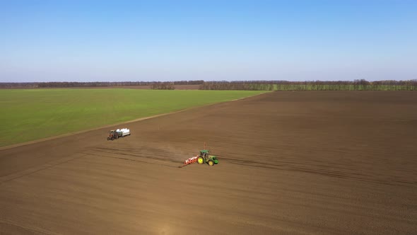 Aerial View of a Tractor on the Field. Preparing the Land for Sowing