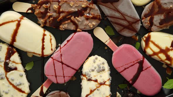 Ice Cream on Stick Coated with Various Chocolate Glazes and Toppings. Top View, Flat Lay alt