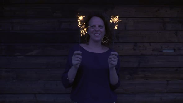Slow motion shot of woman with sparklers