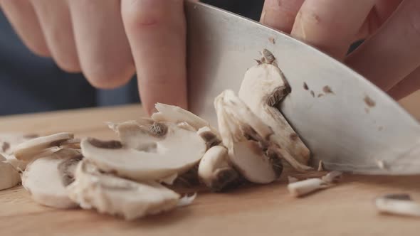 Men Chef Cut Mushrooms with Knife for Salad in the Kitchen and Man Home Cooking alt