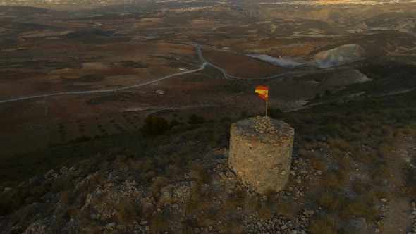 Circling an Old Abandoned Lookout Tower with a Spanish Flag alt