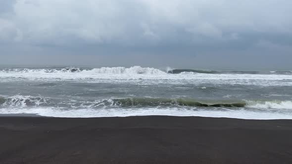 Waves Crashing on Beach in Yogyakarta, Indonesia - Static Shot on Overcast Day alt