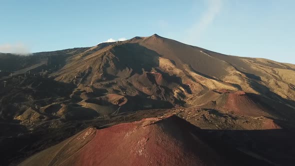 Drone flight over a large crater of the Etna volcano, Sicily, Italy. alt