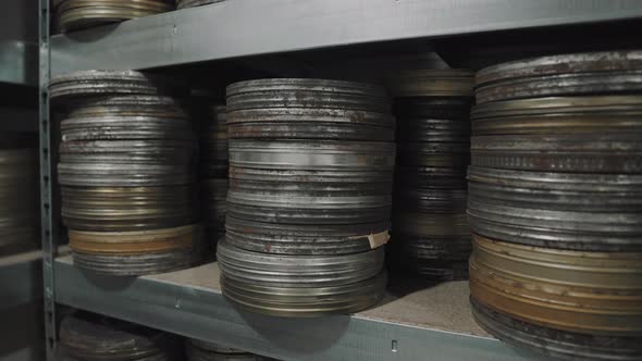 Old round metal boxes, in a dusty vault and leaves.  alt