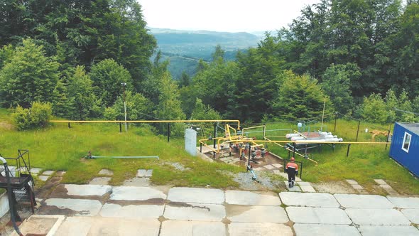 Aerial View A Gas Worker or a Station Operator Inspects a Gas Production Site. alt