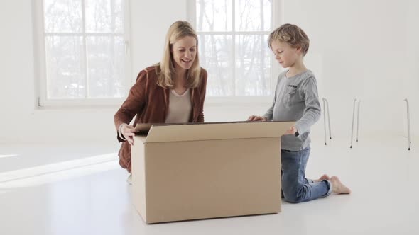 Mother and son opening a box