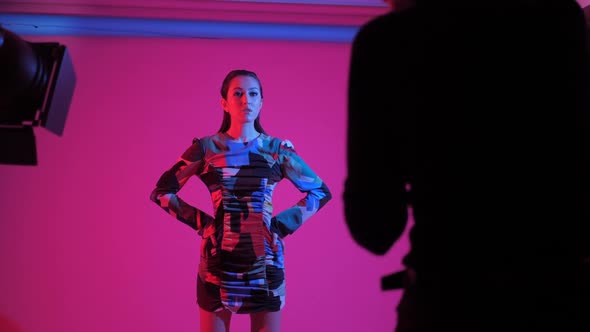 Fashionable Sexy Woman Model of Asian Appearance in a Business Pink Suit alt