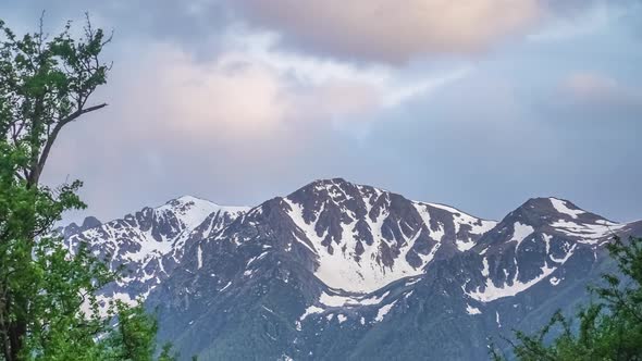 Caucasian Mountain Peak Covered with Snow at Dusk in Cloudy Evening