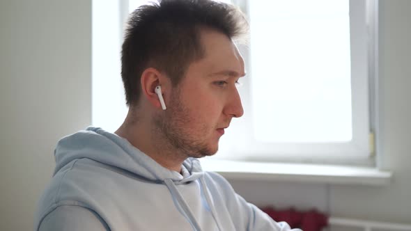 Guy Puts on Wireless Headphones Listens to Music Enjoys Shaking His Head