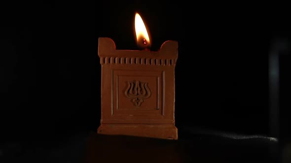 Handmade thea (oil lamp) with the trident symbol.