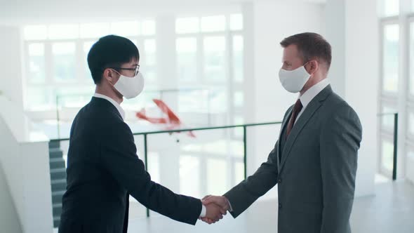 Men In Masks Greeting Each Other alt