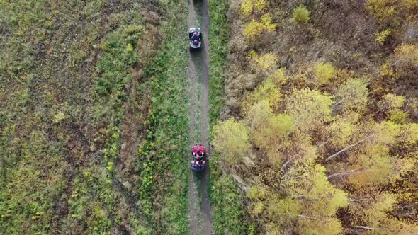 Flying Over ATV Drivers Flat Aerial Photography From a Quadcopter Background Field and Forest