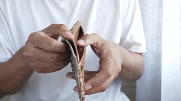 Man Hand Open an Empty Wallet with Copy Space alt
