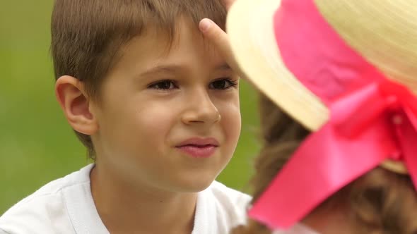 Little Girl Is Stroking the Boy's Hair. Slow Motion. Close Up alt