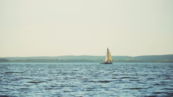 A small yacht sails into the sea in the summer. 