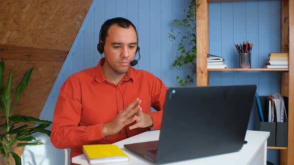 Smiling Young Man Wear Headset Elearning Study with Online Tutor Teacher Talk Conference