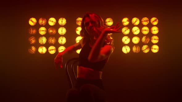 Girl Practicing Erotic Strip Movements Sitting Chair on Nightclub Stage Close Up alt