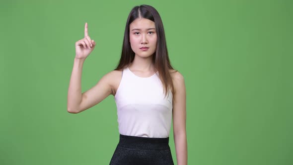 Young Beautiful Asian Businesswoman Pointing Up