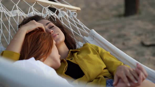 Female couple lying in the hammock