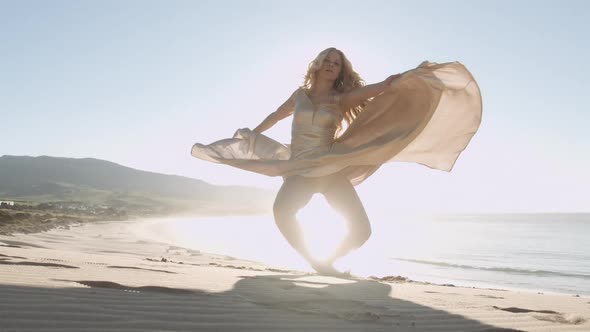 Beautiful Blond Woman In Gold Dress On Sunny Beach alt