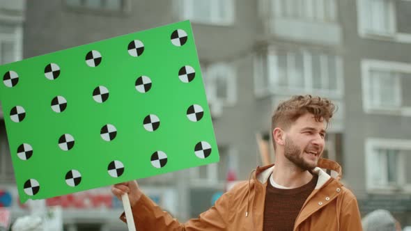 Angry Man Activist on Political Rally. Rebel Revolution Picket Green Placard . alt