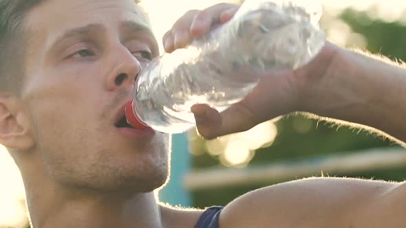 Tired Athlete Restoring Water Balance After Exhausting Workout, Slow-Motion alt