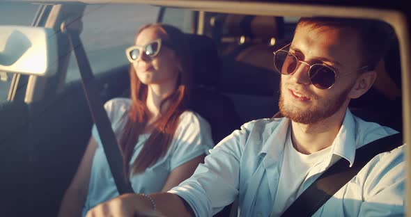 Couple Driving on Sunset