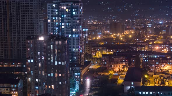 Multistorey Buildings with Changing Window Lighting At Night in City. Timelapse alt