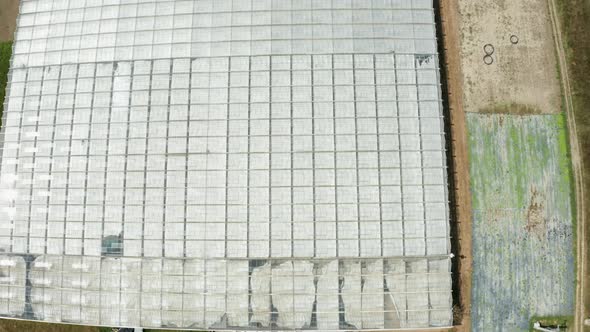Aerial Footage of Drone Flying Over a Greenhouse alt
