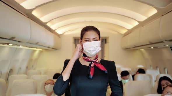Flight attendant demonstrates wearing masks to prevent COVID-19 infection.