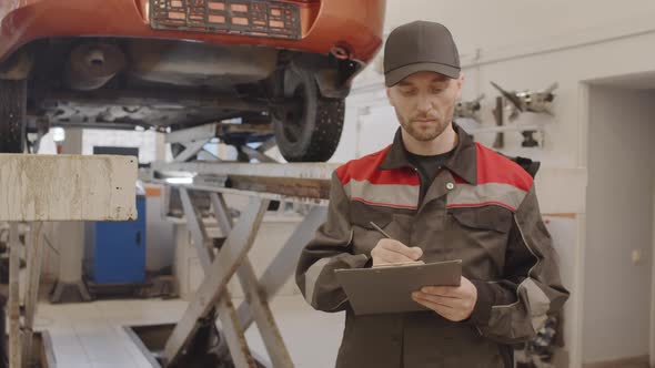 Portrait of Mechanic at Work in Car Repair Shop alt