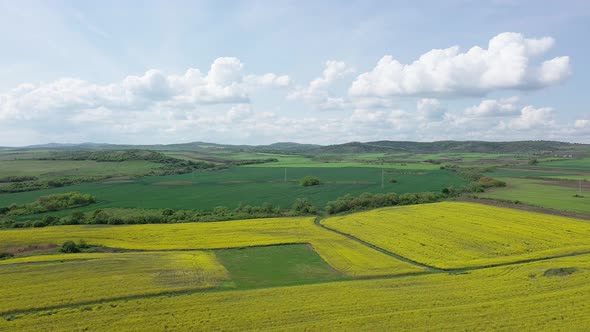 Fields with a Plant in a Valley Against the Background of the Village and the Sky in Bulgaria