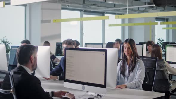 Modern Open Space Corporate Office with Tow Rows Off Businessmen and Businesswomen Working on alt