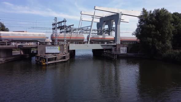Railway bridge over river Vecht in Holland in the city of Weesp, cargo train passing alt