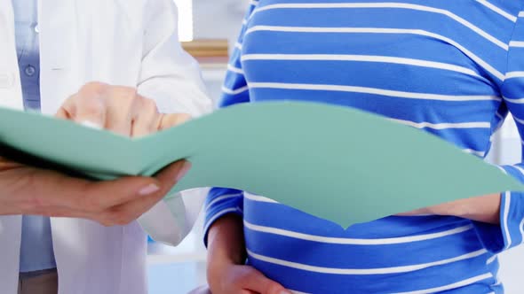 Pregnant woman consulting a female doctor alt