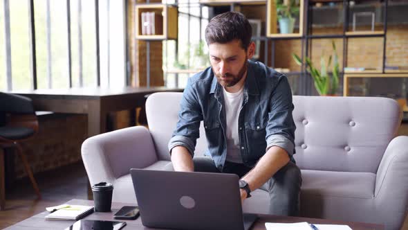 Serious Focused Adult Caucasian Business Man Working on Laptop From Home