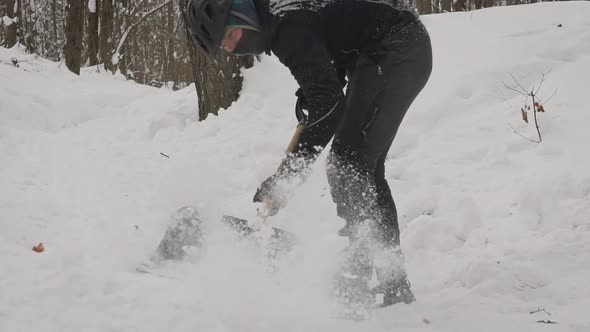 Cyclist Cleans His Springboard with a Shovel in the Winter alt