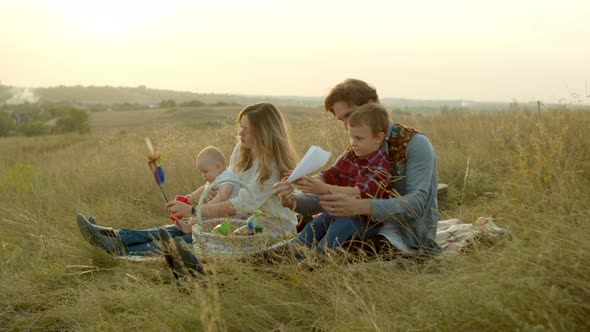 Parents Playing with Kids During Picnic in Field