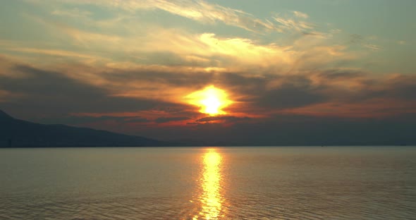 Silhouettes Of Birds Flying In The Ocean At A Tense Orange Twilight Sunset alt