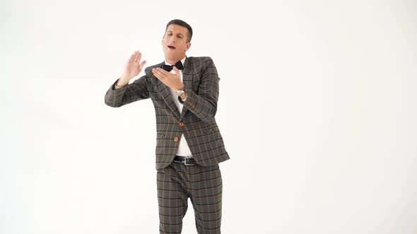 Fun Man in a Gray Checkered Suit is Showing a Scene with Money  alt