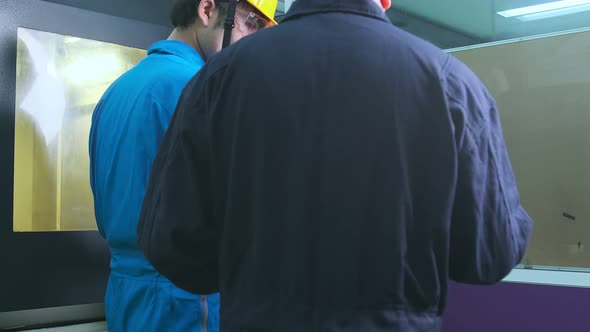 Professional engineering walking discuss inspecting with engineer team machinery factory area alt