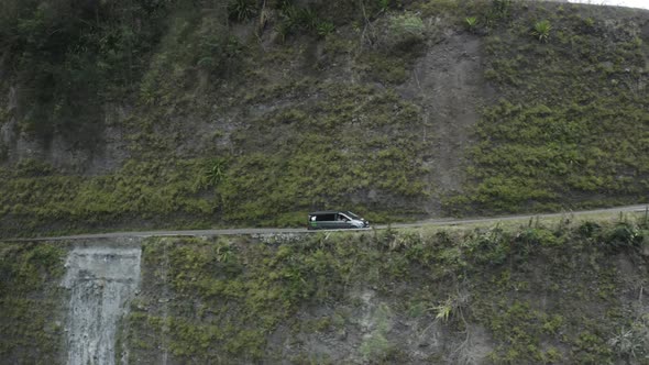 Aerial view of a vehicle driving a twisty road, Reunion. alt